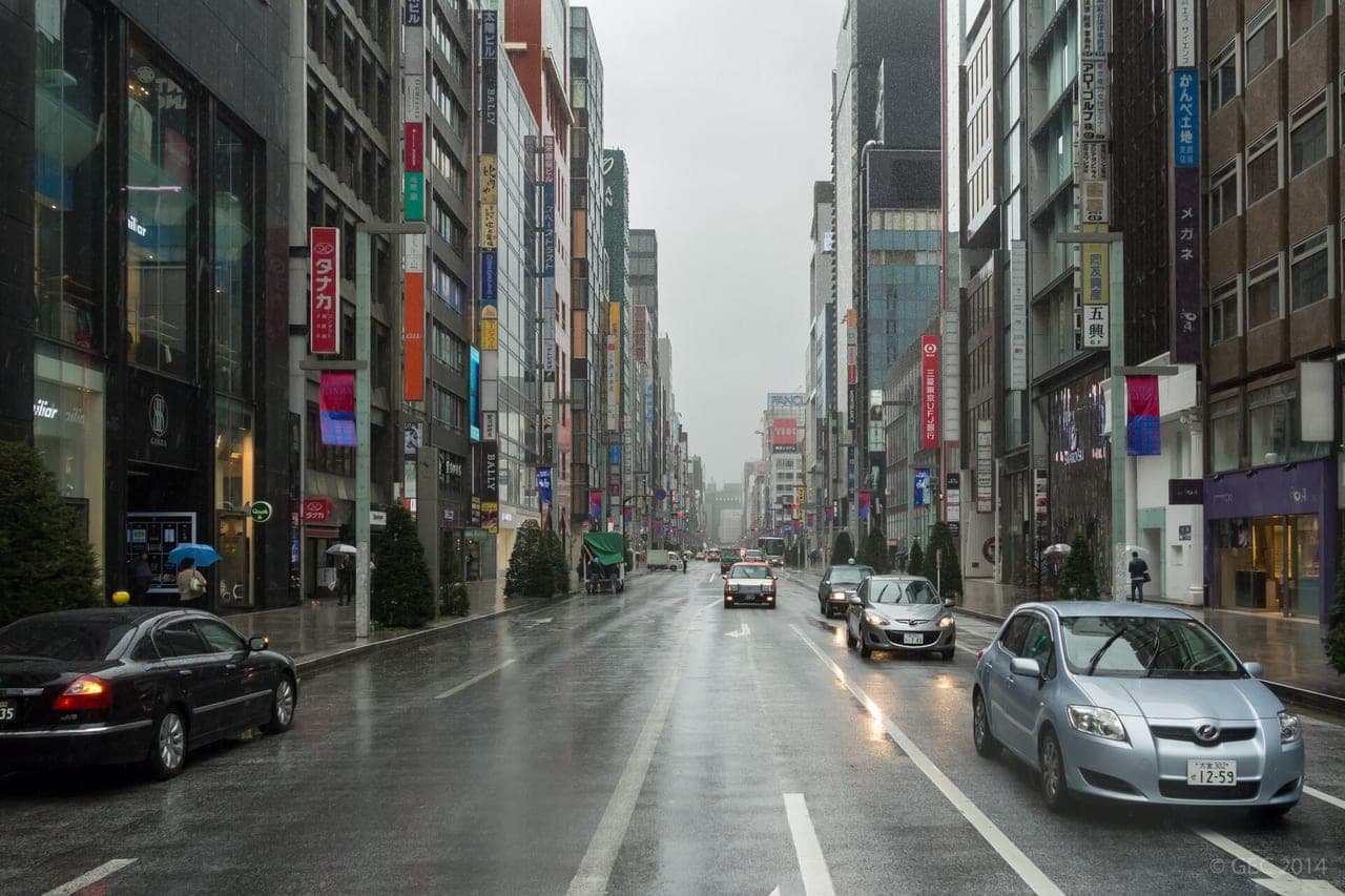 Wide establishing view of Chūō-dōri, Ginza's main luxury street, lined with flagship maisons and (ideally) on a weekend when it is pedestrianized