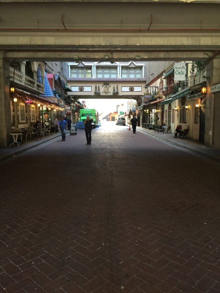 Interior arcade view of LA Jewelry District showing covered walkway with jewellery shops and ornate overhead bridge