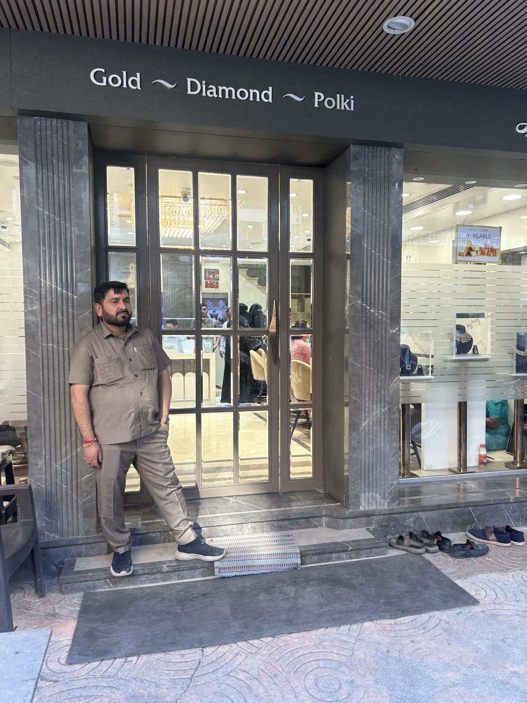 Modern upscale jewellery store entrance with 'Gold ~ Diamond ~ Polki' signage and security guard at the door
