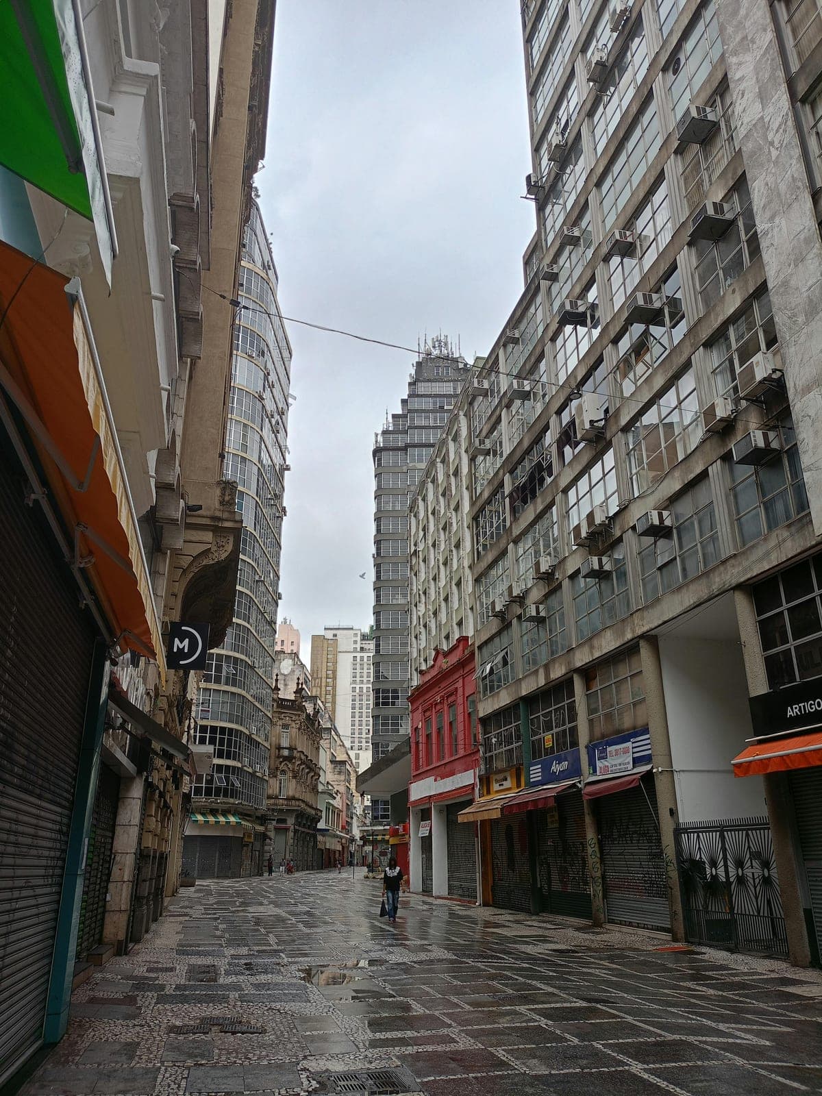 Downtown São Paulo street view showing tall buildings and the distinctive modernist tower